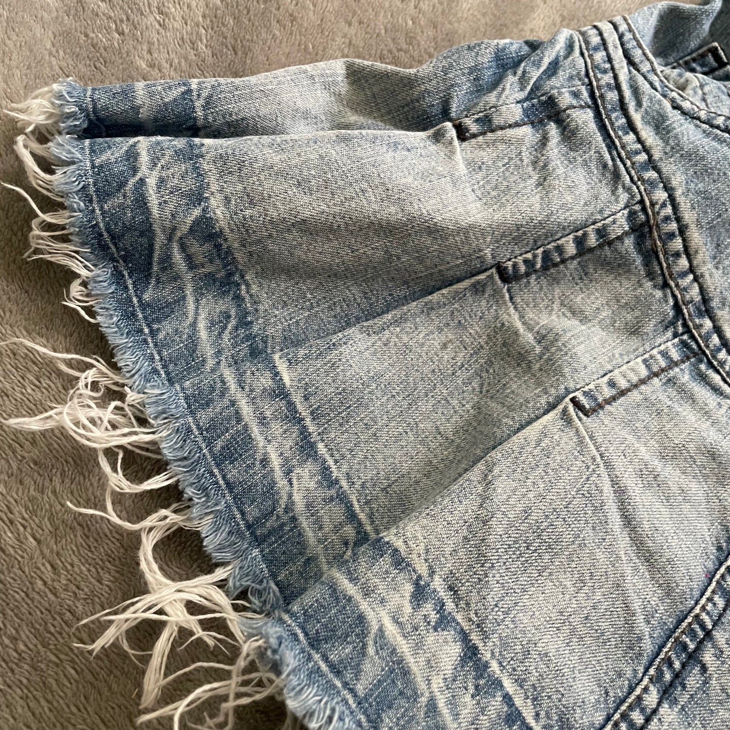 Worn out, pleated denim mini skirt